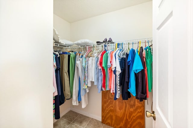 spacious closet with light tile patterned floors