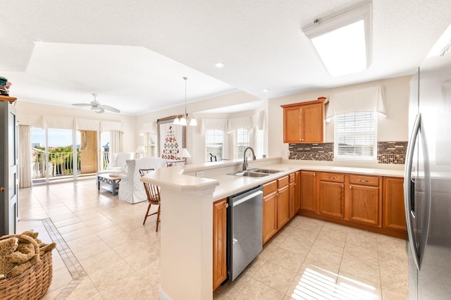 kitchen featuring kitchen peninsula, sink, plenty of natural light, and appliances with stainless steel finishes