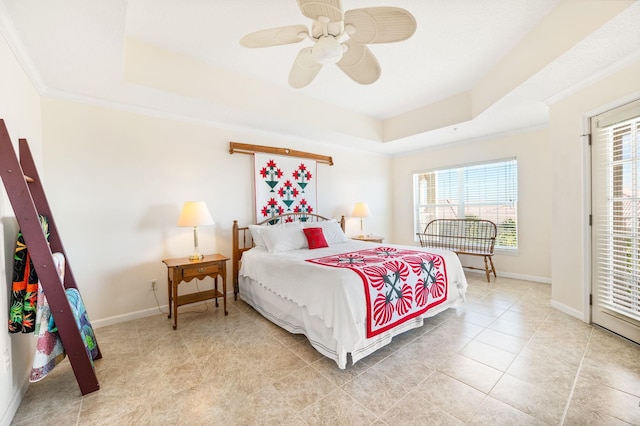 bedroom with a raised ceiling, multiple windows, ceiling fan, and crown molding