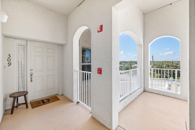 view of exterior entry featuring a balcony