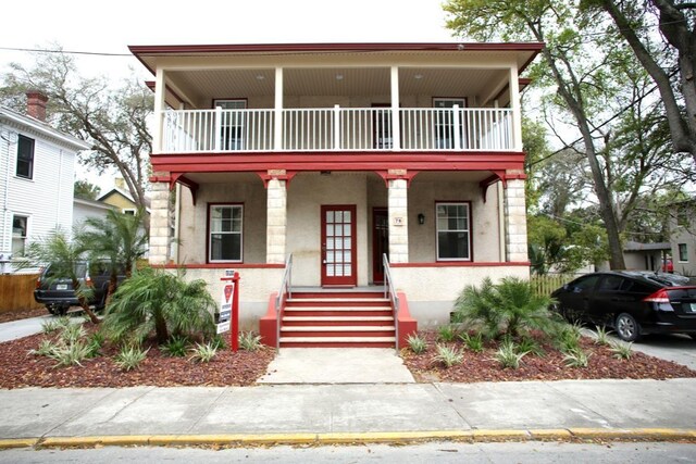 78 Riberia St, Saint Augustine, FL 32084 - view of front facade featuring a balcony, a porch, and stucco siding