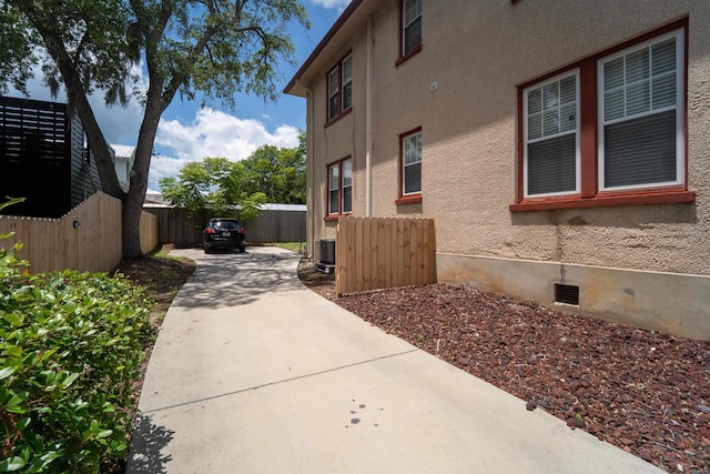 78 Riberia St, Saint Augustine, FL 32084 - view of side of home featuring a patio, stucco siding, driveway, and central AC