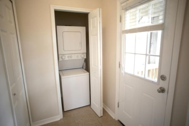 78 Riberia St, Saint Augustine, FL 32084 - laundry area featuring stacked washer and clothes dryer, healthy amount of natural light, baseboards, and light tile patterned floors