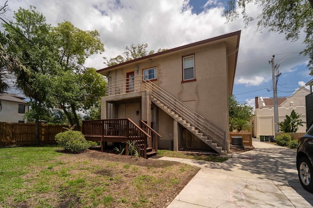 78 Riberia St, Saint Augustine, FL 32084 - back of house with stairs, central air condition unit, and stucco siding