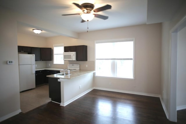 78 Riberia St, Saint Augustine, FL 32084 - kitchen with white appliances, a peninsula, ceiling fan, light countertops, and dark wood finished floors
