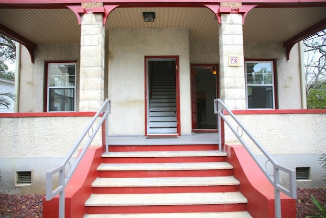78 Riberia St, Saint Augustine, FL 32084 - doorway to property with covered porch and stucco siding