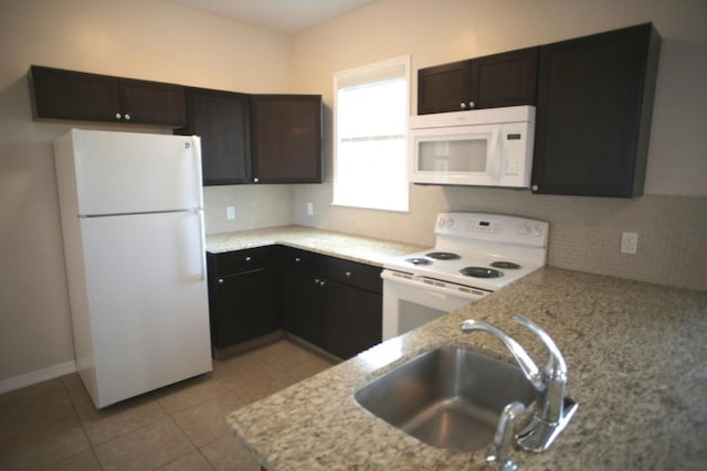 78 Riberia St, Saint Augustine, FL 32084 - kitchen with white appliances, a sink, decorative backsplash, light stone countertops, and light tile patterned flooring