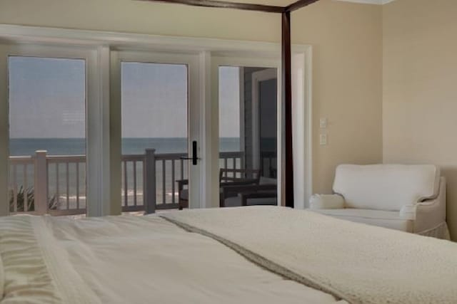 bedroom featuring access to exterior and a water view