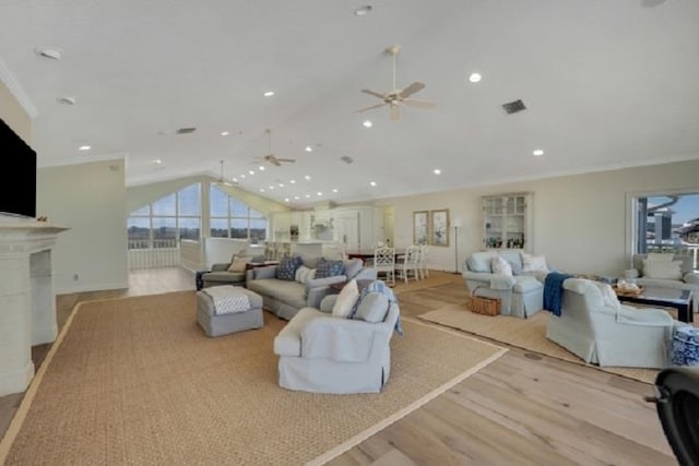 living room with ceiling fan, light hardwood / wood-style floors, lofted ceiling, and crown molding