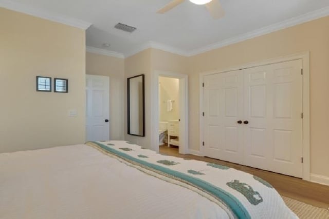 unfurnished bedroom featuring ensuite bath, ceiling fan, crown molding, wood-type flooring, and a closet