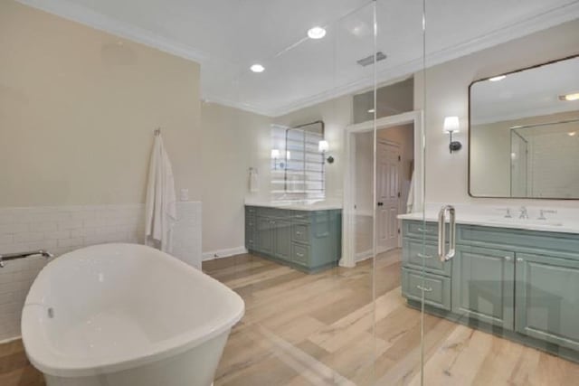 bathroom with vanity, ornamental molding, and tile walls