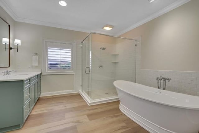 bathroom with hardwood / wood-style flooring, vanity, separate shower and tub, and crown molding