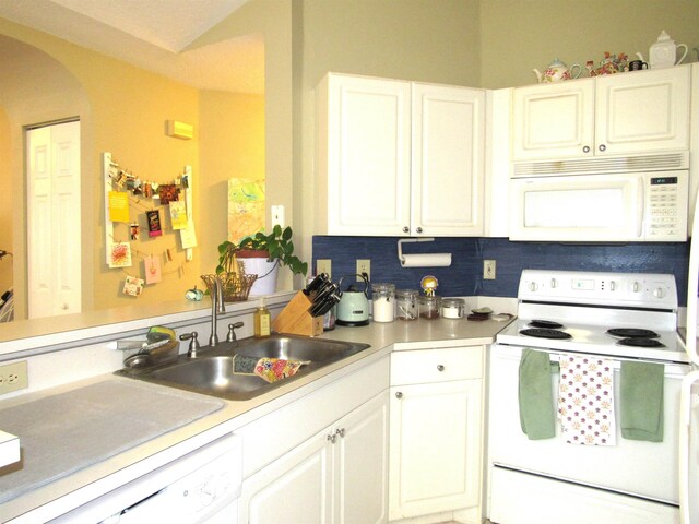 28212 Harbour Vista Cir, Saint Augustine, FL 32080 - kitchen featuring white appliances, a sink, light countertops, arched walkways, and white cabinetry