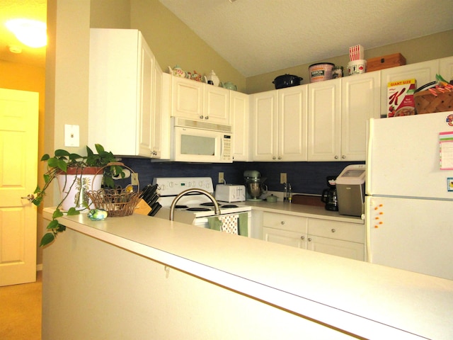 28212 Harbour Vista Cir, Saint Augustine, FL 32080 - kitchen featuring white appliances, light countertops, white cabinets, and vaulted ceiling