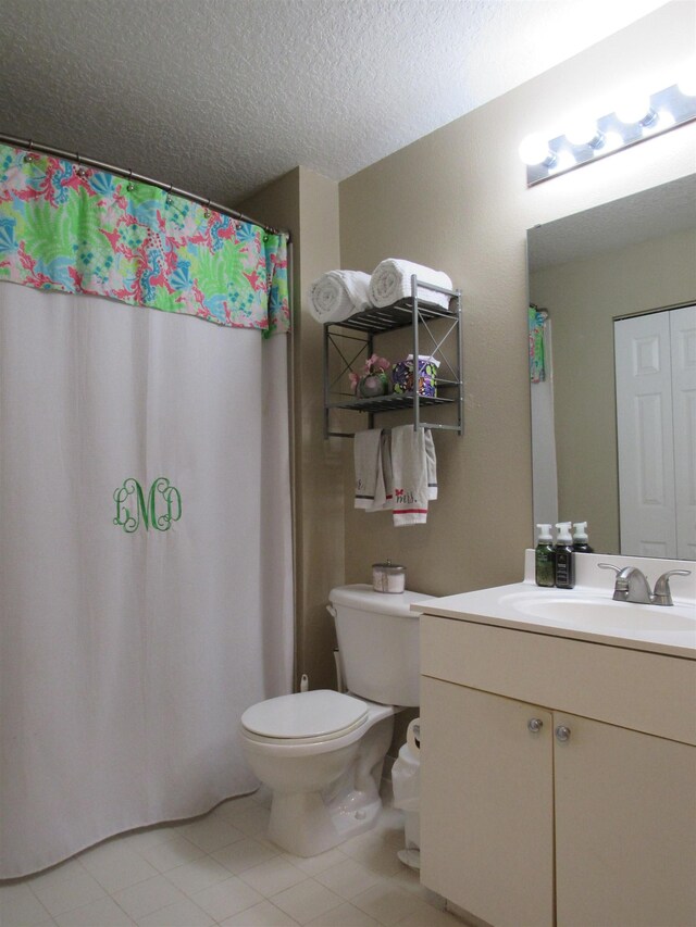 28212 Harbour Vista Cir, Saint Augustine, FL 32080 - bathroom featuring vanity, toilet, tile patterned floors, a textured ceiling, and a shower with shower curtain