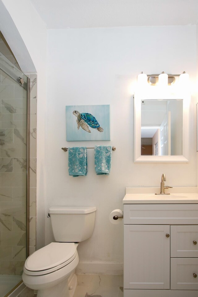 35103 Harbour Vista Cir, Saint Augustine, FL 32080 - bathroom with a shower stall, vanity, baseboards, toilet, and marble finish floor