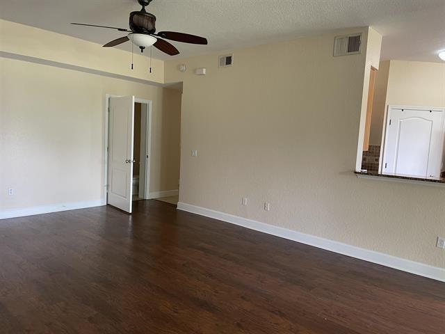 623 Shores Blvd, Saint Augustine Shores, FL 32086 - spare room with a textured ceiling, dark hardwood / wood-style floors, and ceiling fan