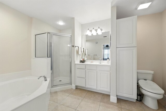 623 Shores Blvd, Saint Augustine Shores, FL 32086 - full bathroom featuring vanity, a shower stall, a garden tub, tile patterned floors, and toilet