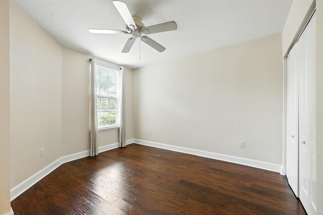 623 Shores Blvd, Saint Augustine Shores, FL 32086 - unfurnished bedroom with dark wood-style floors, a closet, baseboards, and ceiling fan