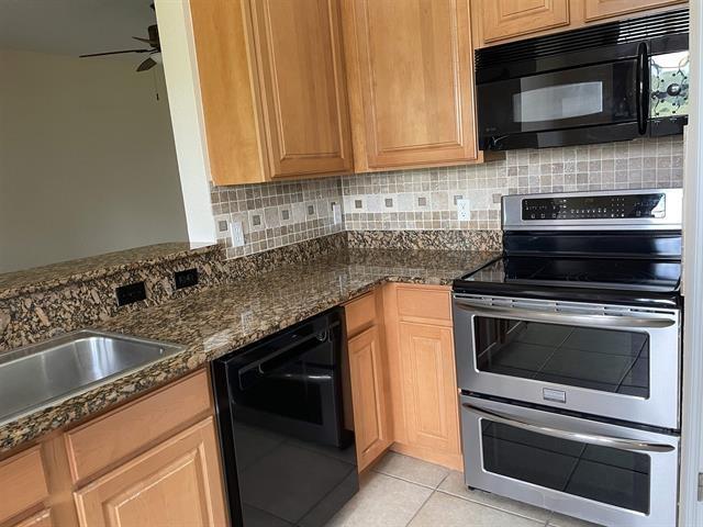 623 Shores Blvd, Saint Augustine Shores, FL 32086 - kitchen featuring dark stone counters, black appliances, decorative backsplash, ceiling fan, and light tile patterned floors