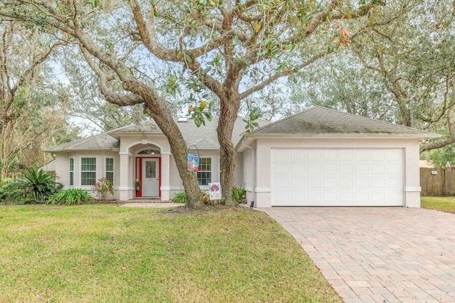 ranch-style home featuring a garage and a front yard