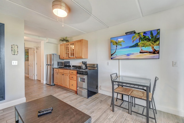 kitchen featuring sink, stainless steel appliances, and light wood-type flooring