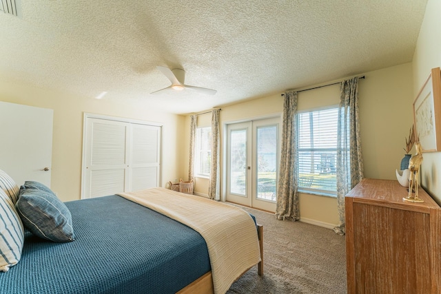 bedroom featuring visible vents, a ceiling fan, a closet, french doors, and carpet