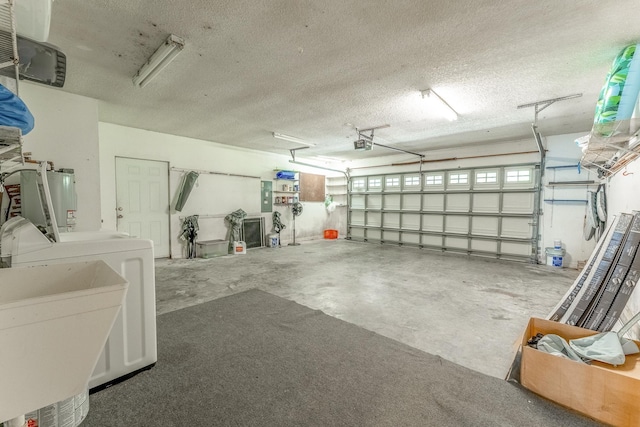 garage with washing machine and clothes dryer, electric panel, water heater, a sink, and a garage door opener