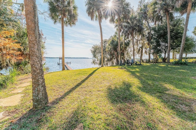 view of yard featuring a boat dock and a water view