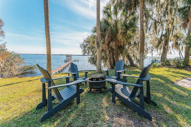 view of yard featuring a fire pit and a water view