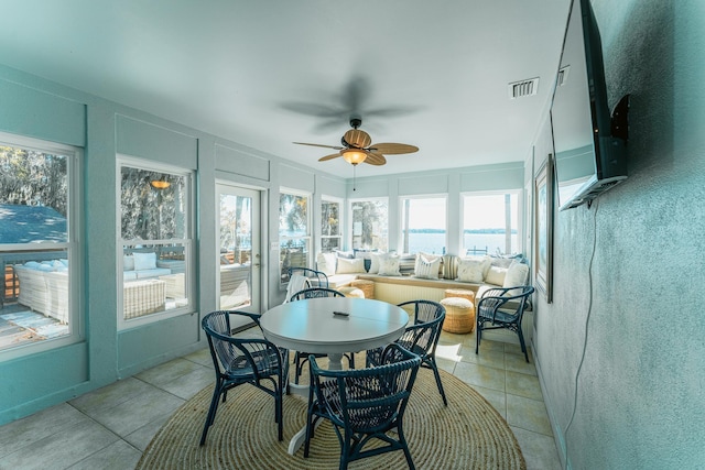 sunroom with a ceiling fan and visible vents