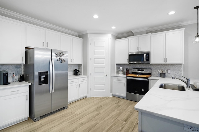 5450 A1A, Saint Augustine, FL 32080 - kitchen with appliances with stainless steel finishes, crown molding, backsplash, white cabinets, and light wood finished floors