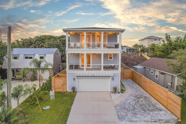 5450 A1A, Saint Augustine, FL 32080 - coastal inspired home featuring a balcony, driveway, a porch, and an attached garage