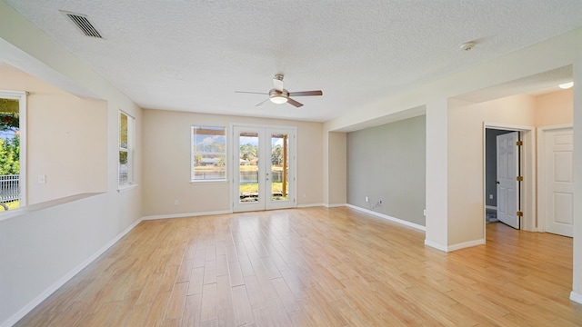 spare room with french doors, ceiling fan, light hardwood / wood-style flooring, and a textured ceiling