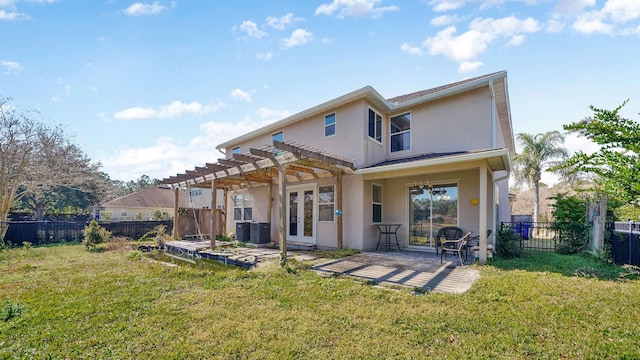 rear view of house featuring central AC, a pergola, a patio area, and a lawn