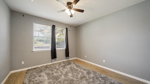 spare room with wood-type flooring, a textured ceiling, and ceiling fan