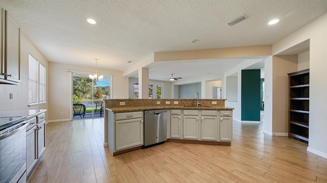 kitchen with sink, hanging light fixtures, light wood-type flooring, an island with sink, and stainless steel appliances