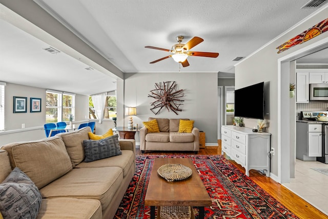 215 Jasmine Rd, Saint Augustine, FL 32086 - living room with a ceiling fan, light wood finished floors, and baseboards