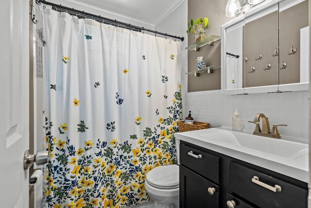 215 Jasmine Rd, Saint Augustine, FL 32086 - bathroom featuring toilet, vanity, decorative backsplash, tile walls, and crown molding