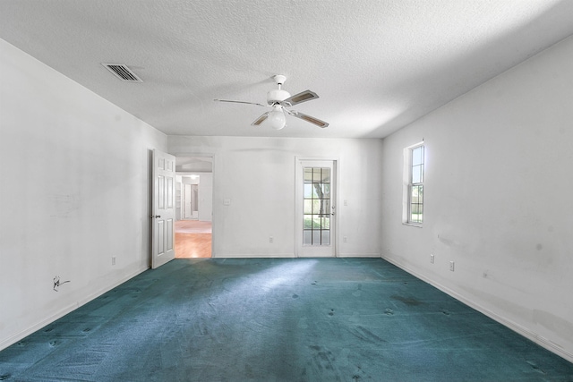 885 Wildwood Dr, Saint Augustine, FL 32086 - unfurnished room with carpet flooring, a ceiling fan, and a textured ceiling