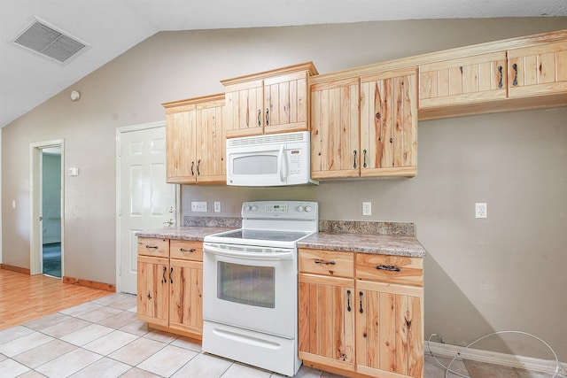 885 Wildwood Dr, Saint Augustine, FL 32086 - kitchen with white appliances, vaulted ceiling, light brown cabinetry, light countertops, and light tile patterned flooring