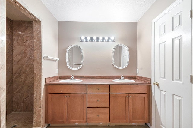 885 Wildwood Dr, Saint Augustine, FL 32086 - full bathroom featuring double vanity, tiled shower, and a textured ceiling