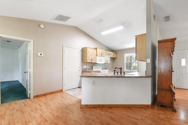 885 Wildwood Dr, Saint Augustine, FL 32086 - kitchen with white appliances, light wood-style flooring, a peninsula, lofted ceiling, and light brown cabinets