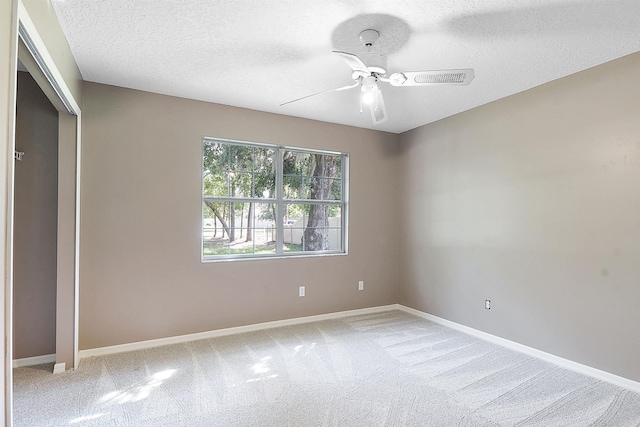 885 Wildwood Dr, Saint Augustine, FL 32086 - unfurnished bedroom with light colored carpet, a textured ceiling, and ceiling fan
