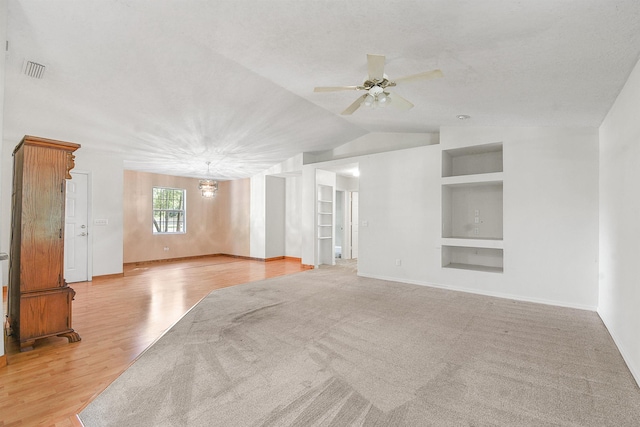 885 Wildwood Dr, Saint Augustine, FL 32086 - unfurnished living room featuring built in features, ceiling fan, lofted ceiling, and light wood-style floors