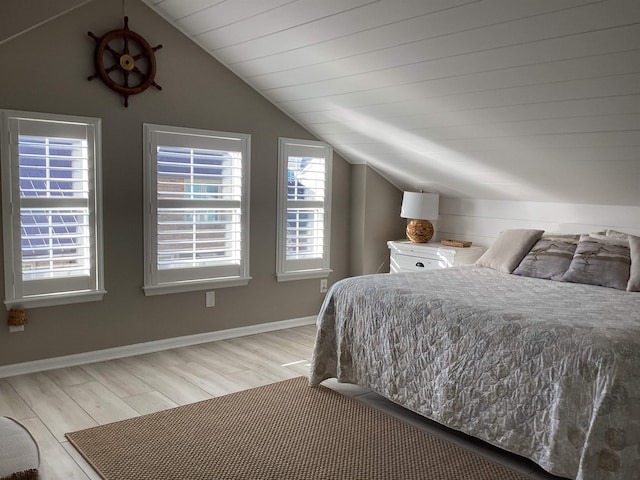 bedroom featuring light hardwood / wood-style flooring and vaulted ceiling