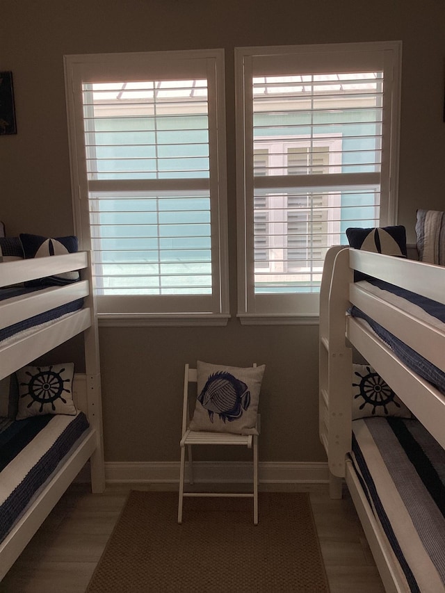 bedroom featuring multiple windows and hardwood / wood-style flooring