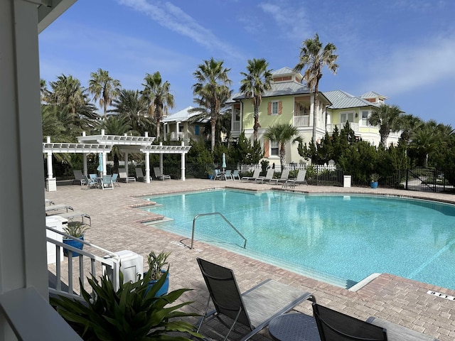 view of swimming pool with a patio area and a pergola