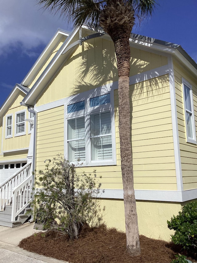 view of side of home featuring a garage