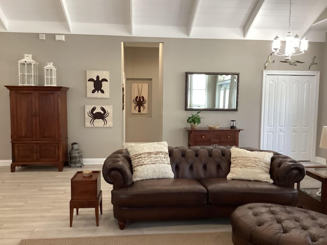 living room with light wood-type flooring and an inviting chandelier